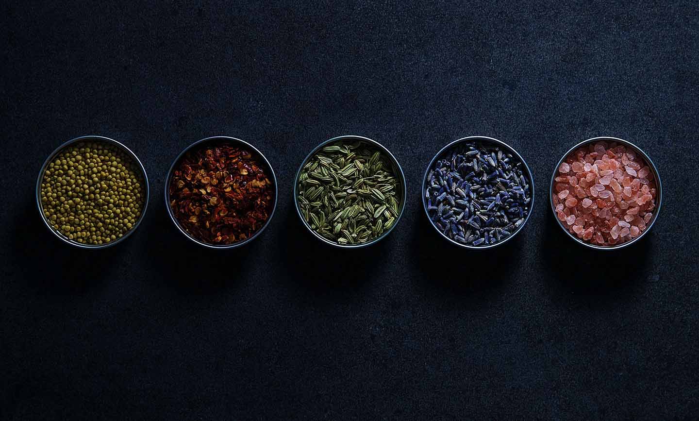 bowls of spices on dark background