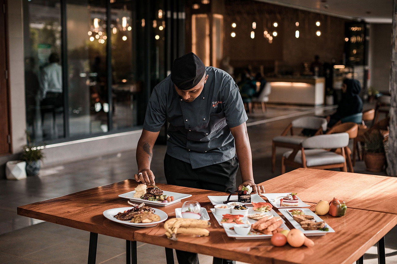 man prepping plates of food