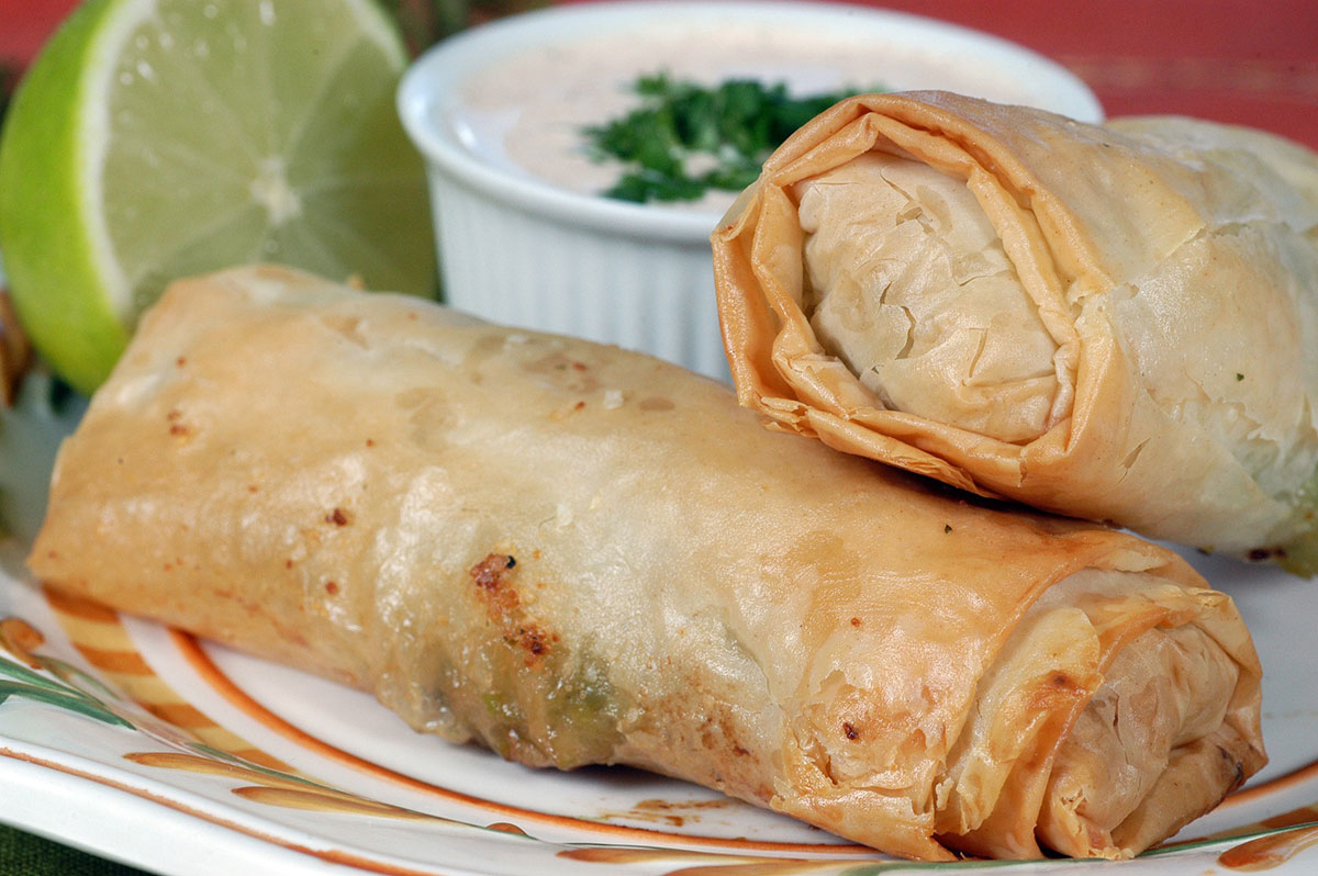 egg roll on a plate with a dipping sauce