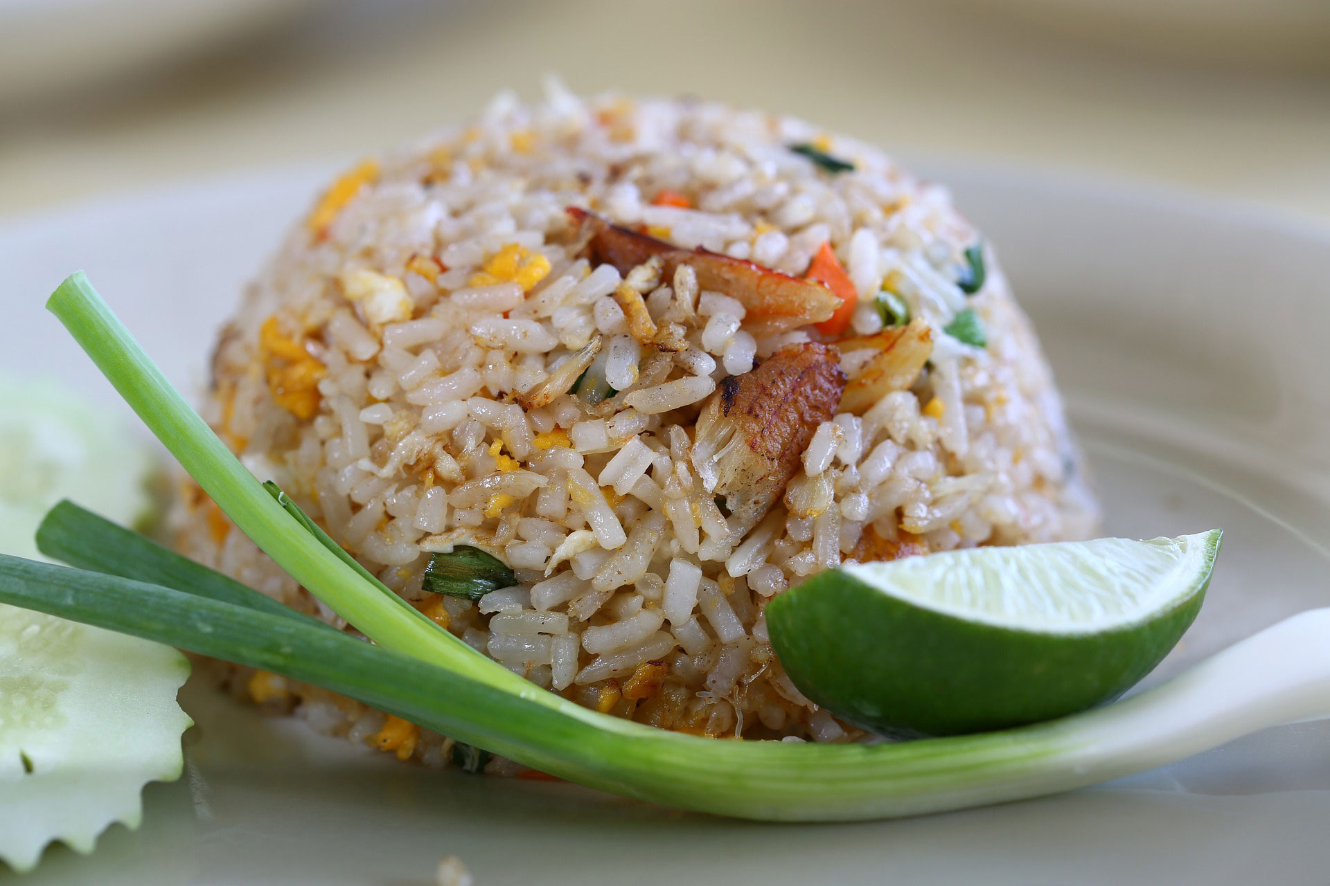 fried rice with a green onion and wedge of lime